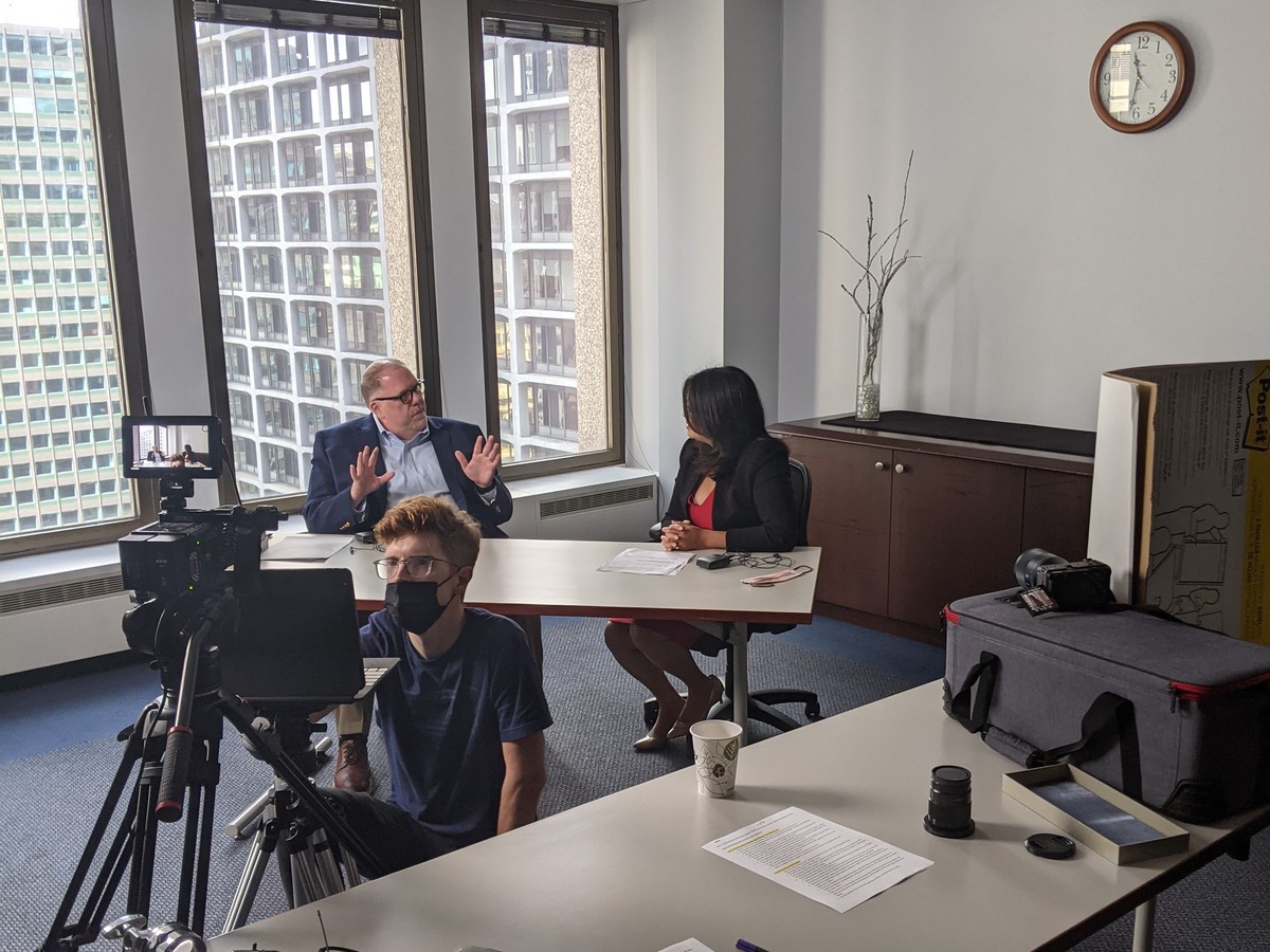 Gigi's team filming an on-camera interview for Children's Home & Aid coverage