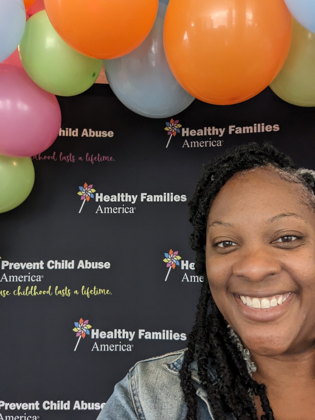 Gigi at PCAA's sold-out national conference, in front of the rebranded Healthy Families America / Prevent Child Abuse America step and repeat